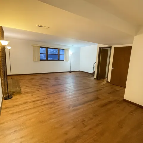 an empty room with wooden floor and closet