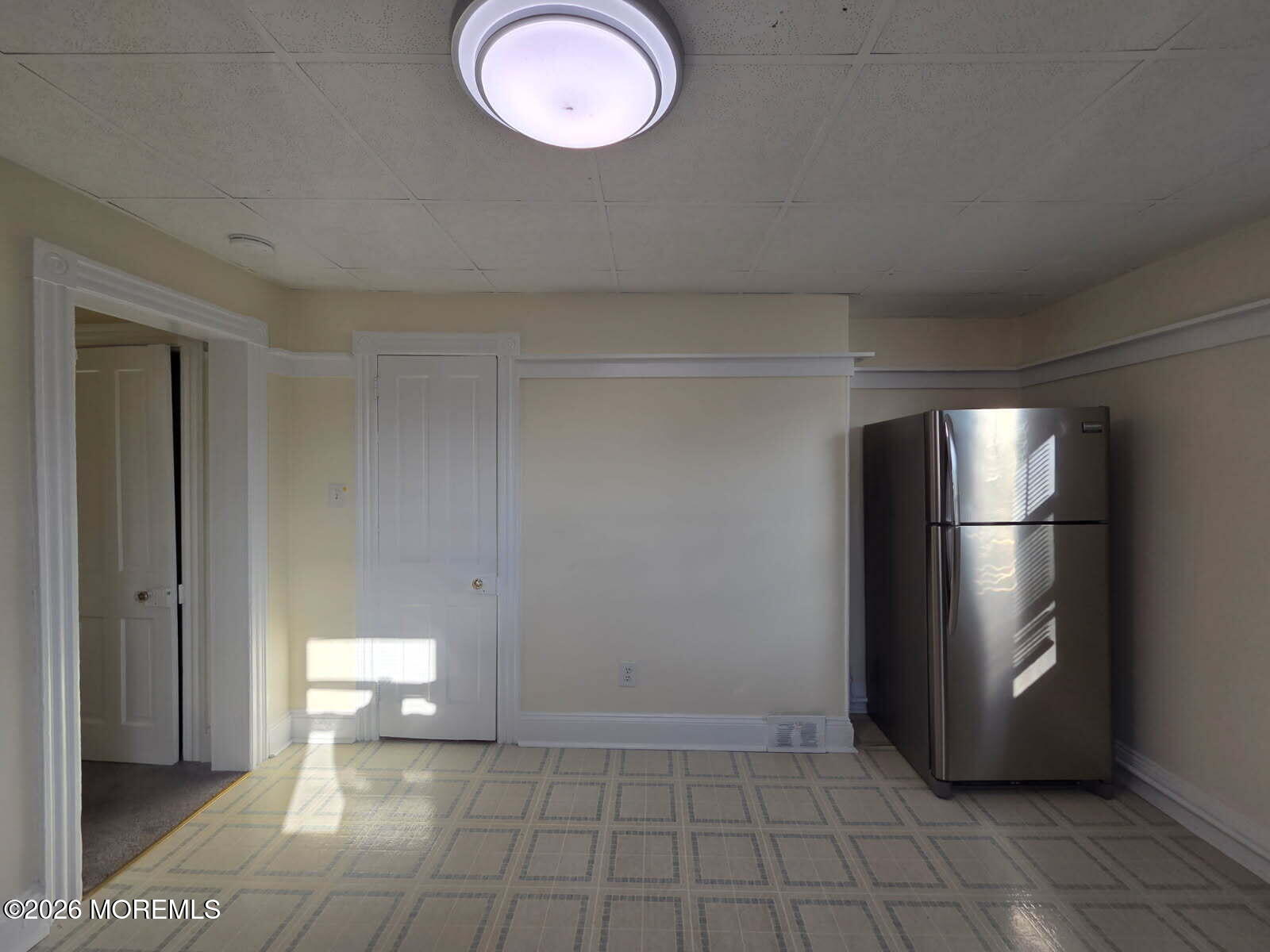 24 Rector Place, Unit 24B Red Bank, NJ 07701 - Photo 1 of 17 a view of a refrigerator in kitchen and an empty room