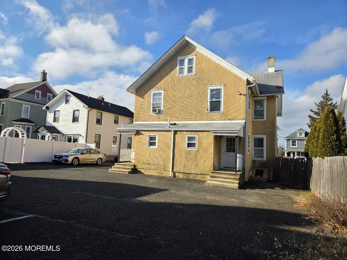 24 Rector Place, Unit 24B Red Bank, NJ 07701 - Photo 13 of 17 a view of a white house that has a car parked front of it