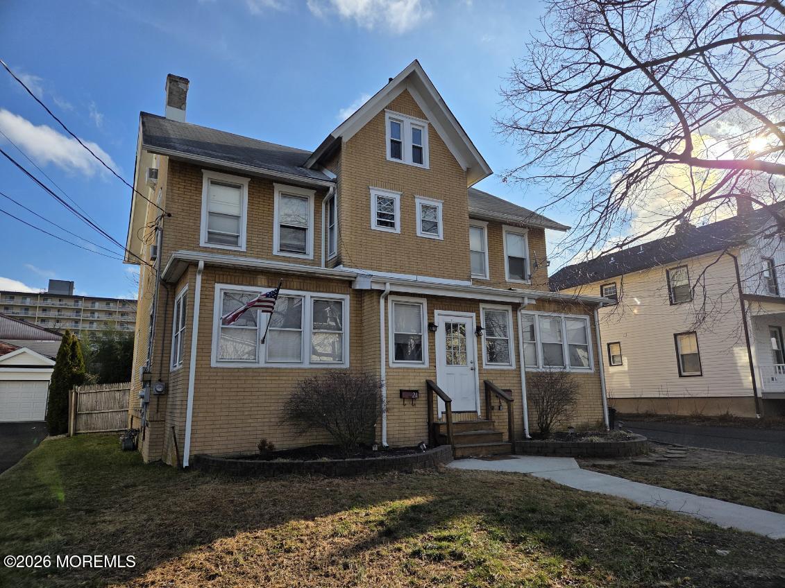 24 Rector Place, Unit 24B Red Bank, NJ 07701 - Photo 16 of 17 a front view of a house with a yard