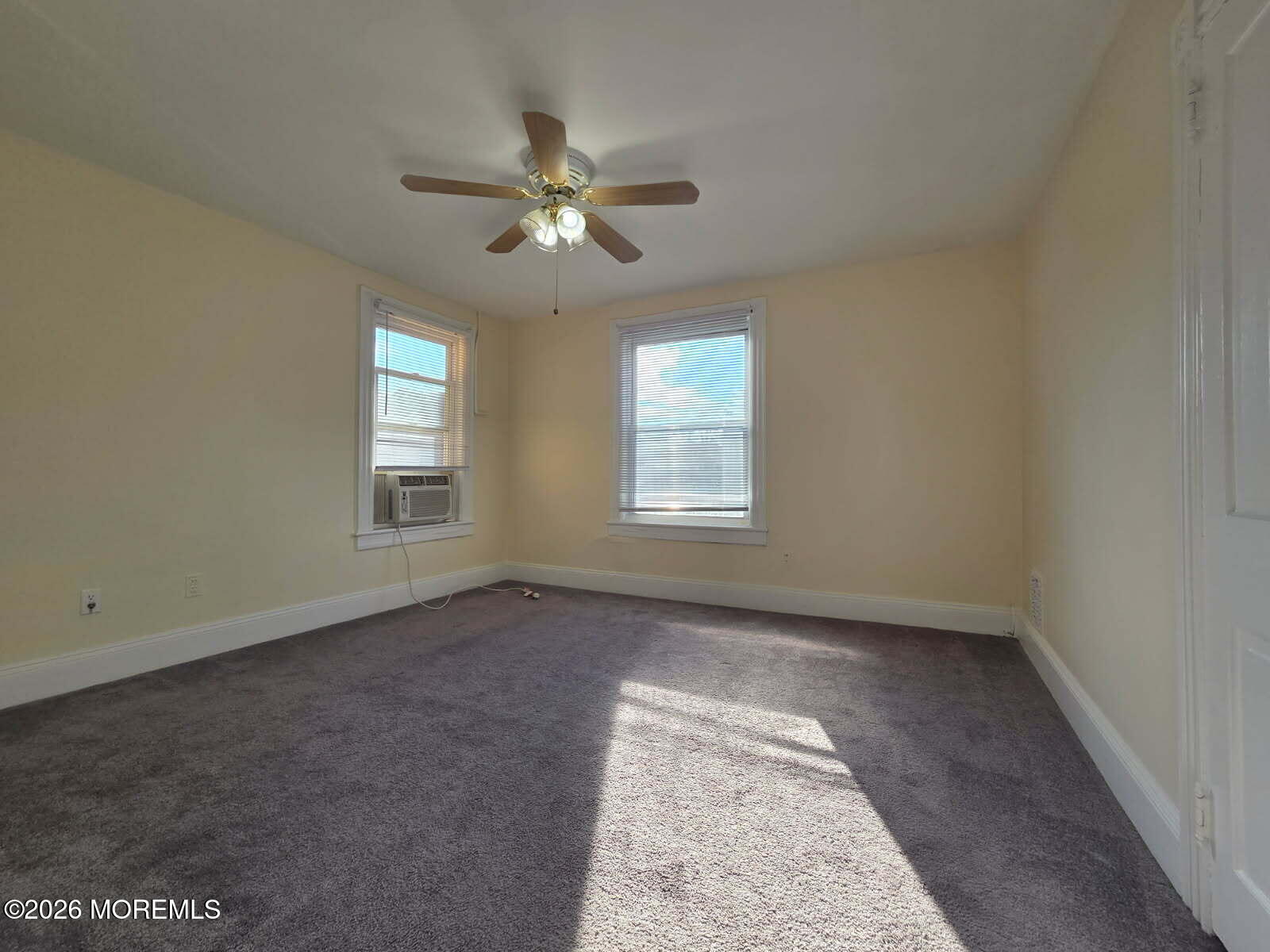 24 Rector Place, Unit 24B Red Bank, NJ 07701 - Photo 4 of 17 an empty room with windows and fan