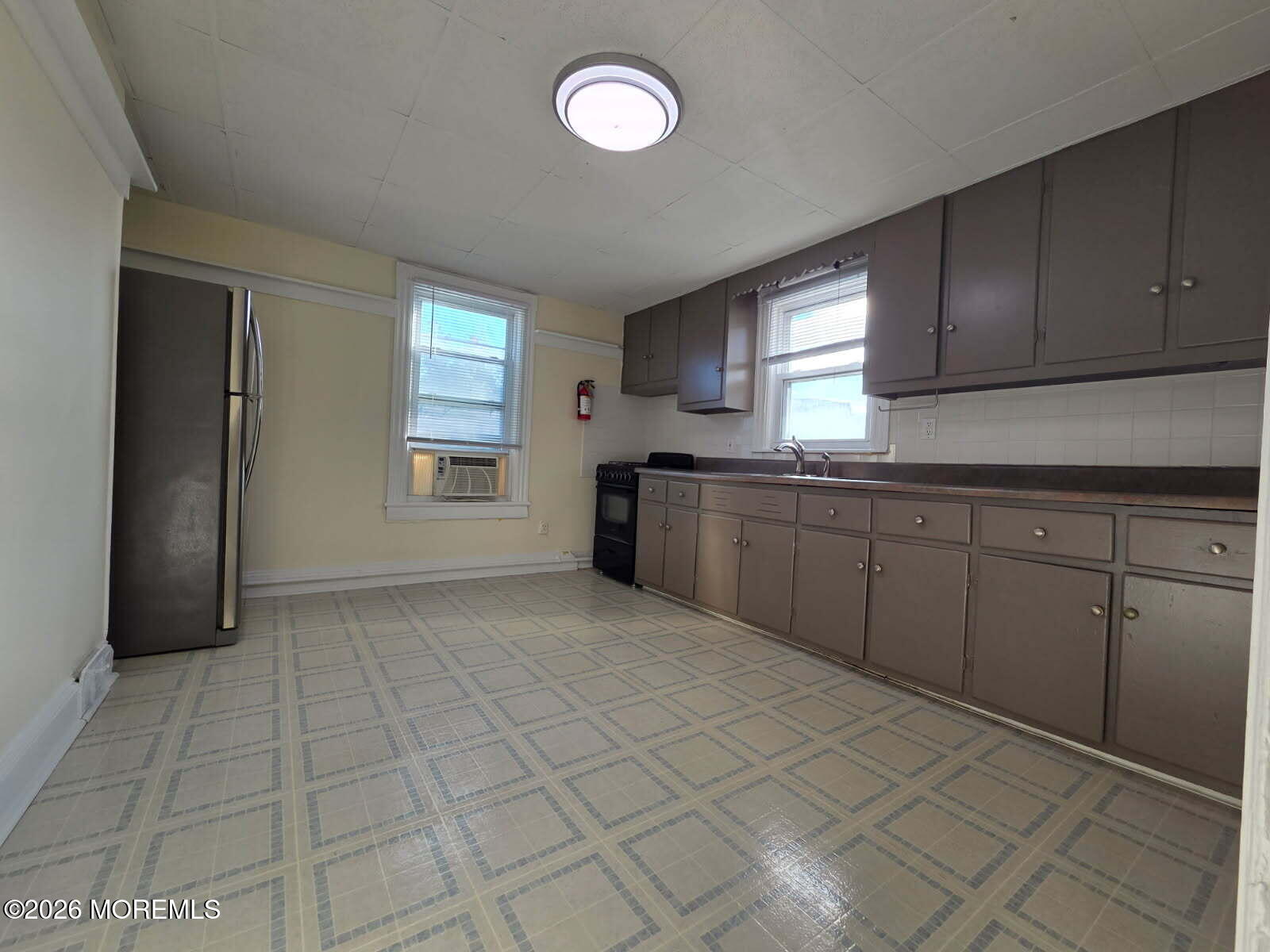 24 Rector Place, Unit 24B Red Bank, NJ 07701 - Photo 7 of 17 a kitchen with stainless steel appliances granite countertop a stove a sink and a refrigerator