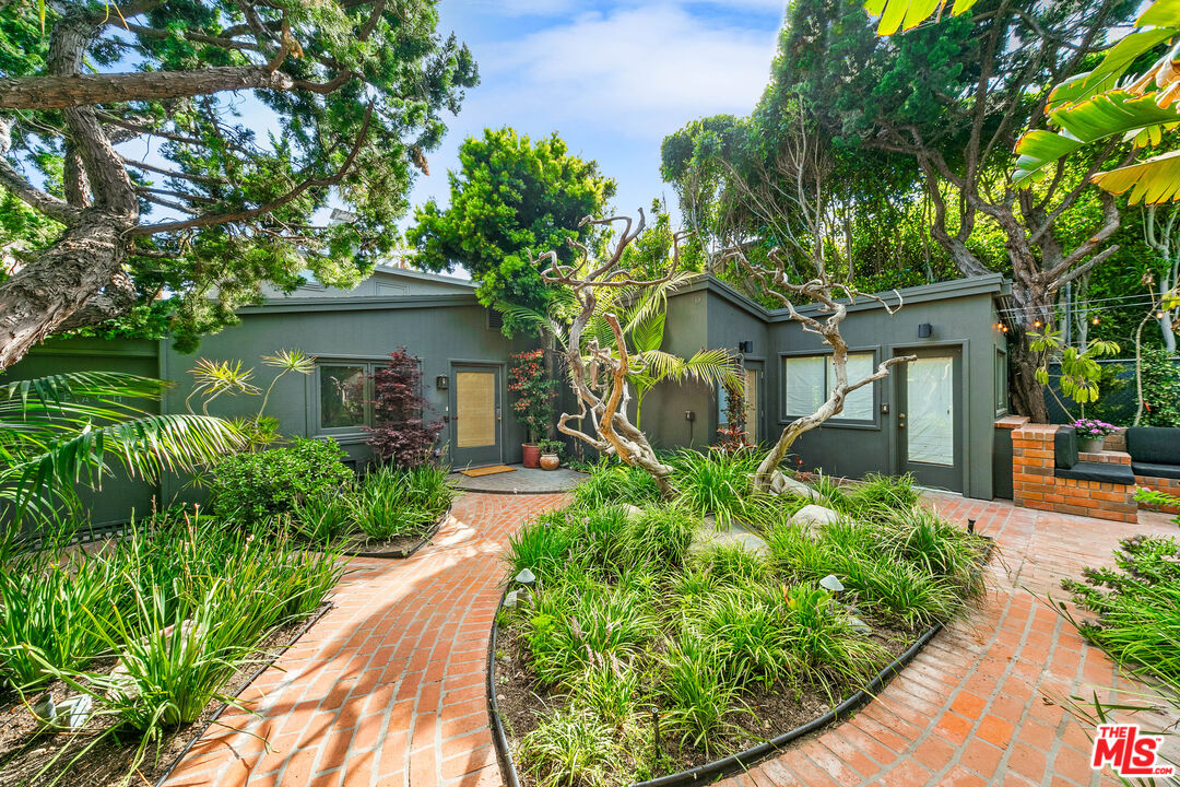 31008 Broad Beach Road Malibu, CA 90265 - Photo 14 of 41 a front view of a house with a yard and potted plants