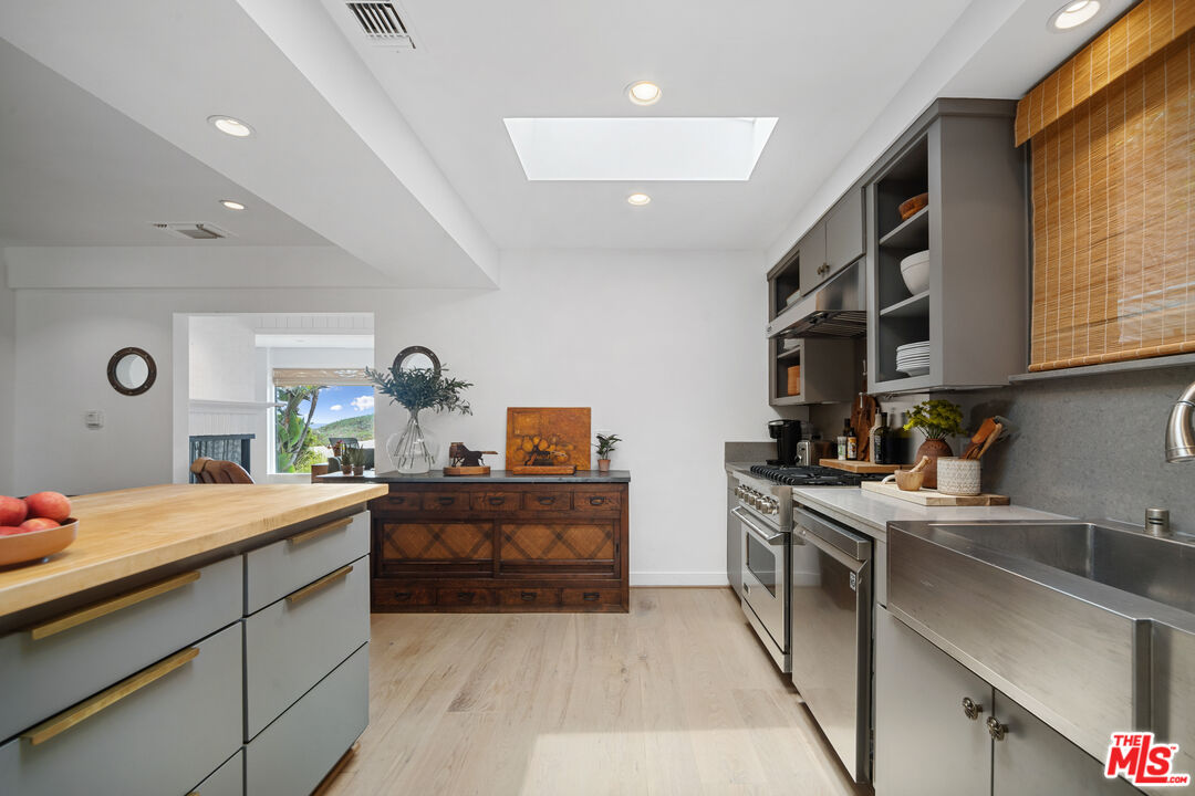 31008 Broad Beach Road Malibu, CA 90265 - Photo 17 of 41 a kitchen that has a lot of cabinets in it and wooden floors