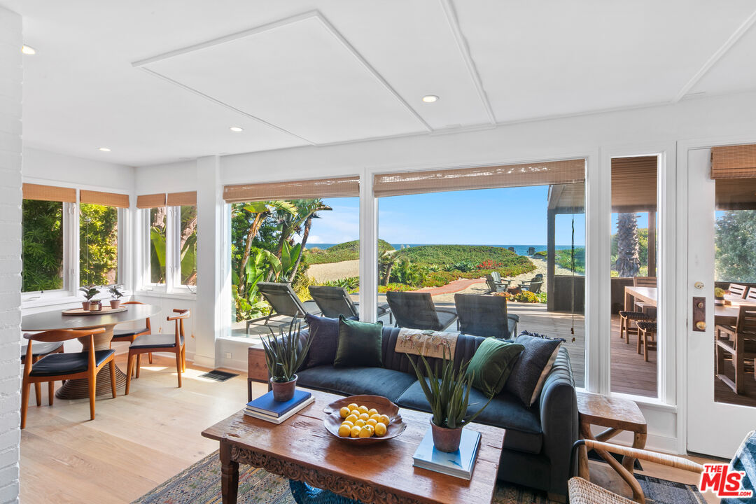 31008 Broad Beach Road Malibu, CA 90265 - Photo 4 of 41 a living room with furniture and floor to ceiling windows