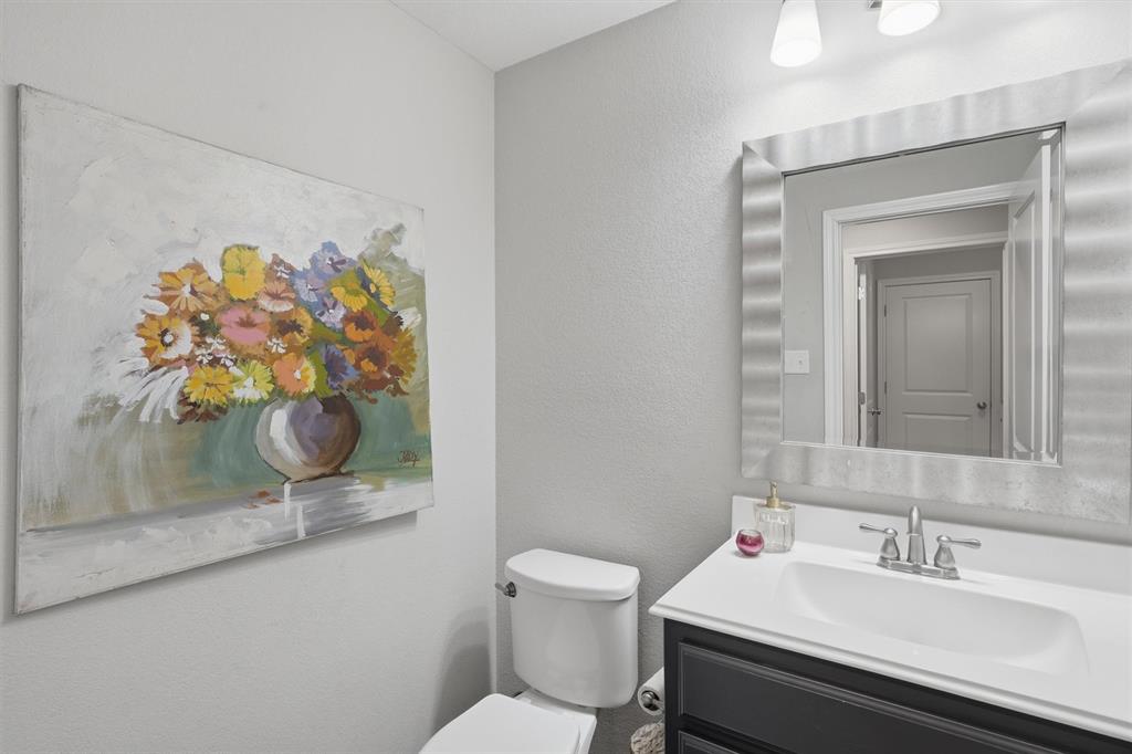 7224 Prestwick Terrace Benbrook, TX 76126 - Photo 22 of 26 Private guest powder room situated in a secluded area of the home. Features a modern vanity and updated fixtures, perfectly positioned for entertaining and daily convenience