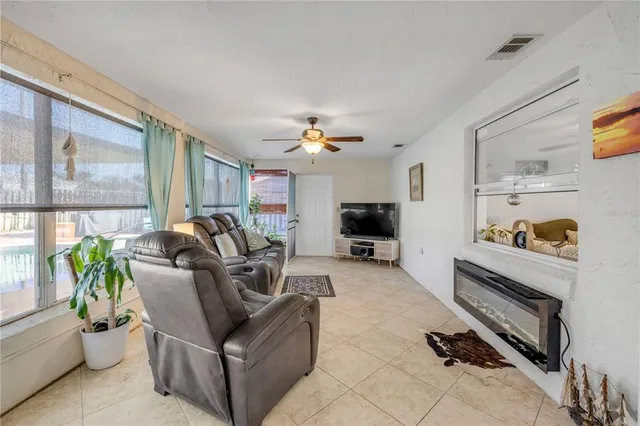 a living room with furniture gym equipment and a flat screen tv