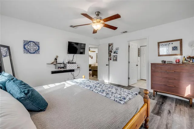 a bedroom with a bed and wooden floor