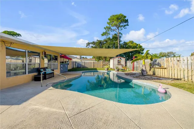a view of a swimming pool with a patio