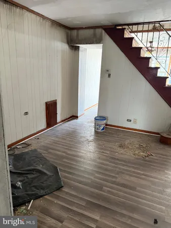 a view of a room with wooden floor