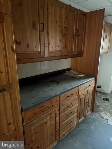 a kitchen with granite countertop cabinets and white appliances