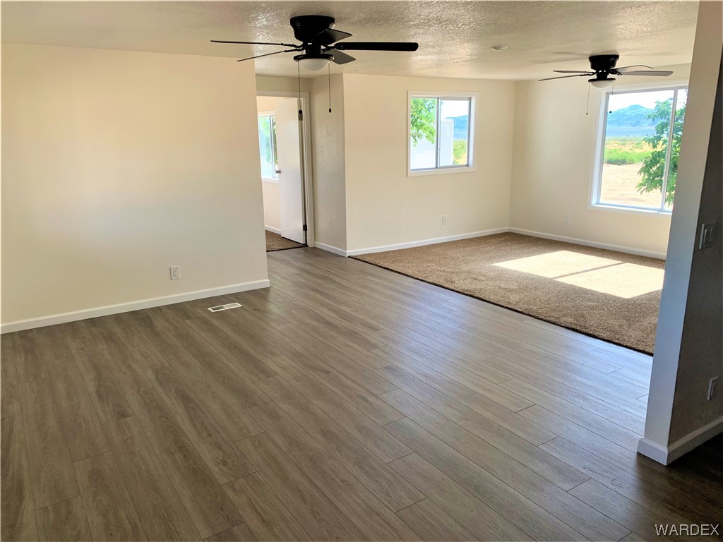 655 South Arivaca Road Golden Valley, AZ 86413 - Photo 9 of 29 an empty room with wooden floor and windows