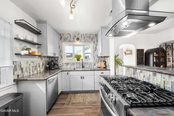 a kitchen with lots of counter top space and a sink