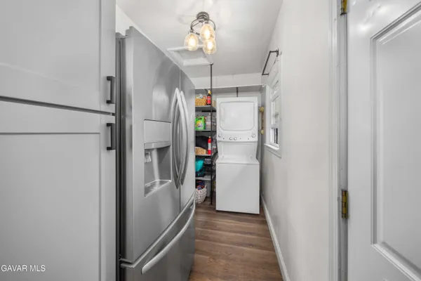 a view of a hallway view with staircase and kitchen view