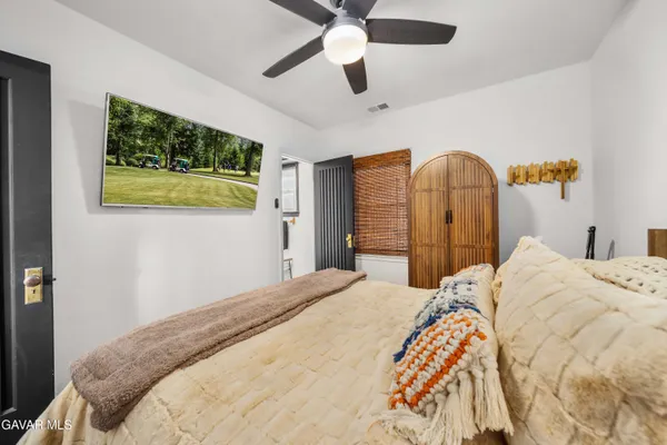 a bedroom with a bed and a chandelier