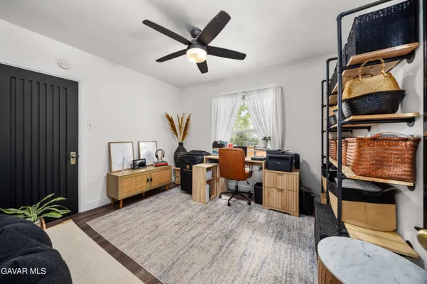 a bed room with furniture and a flat screen tv
