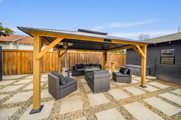 a patio with patio a couch and chairs