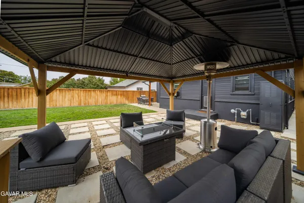 a view of a patio with couches chairs and a yard