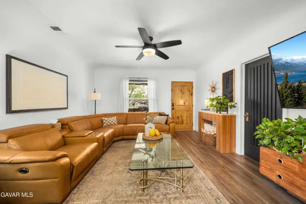 a living room with furniture and a potted plant