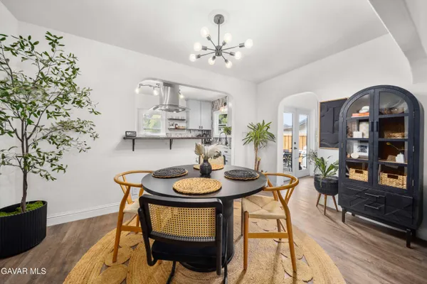 a dining room with furniture and wooden floor