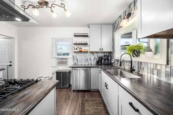 a kitchen with a sink stove and cabinets