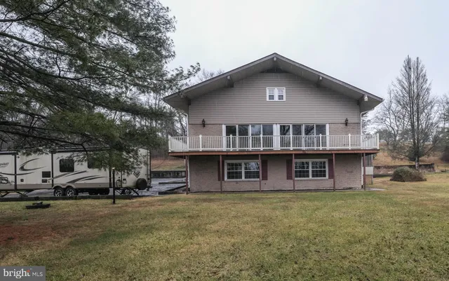 a bathroom with a toilet a sink a shower and a mirror
