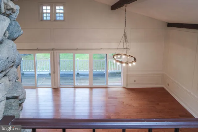 a view of hallway with wooden floor