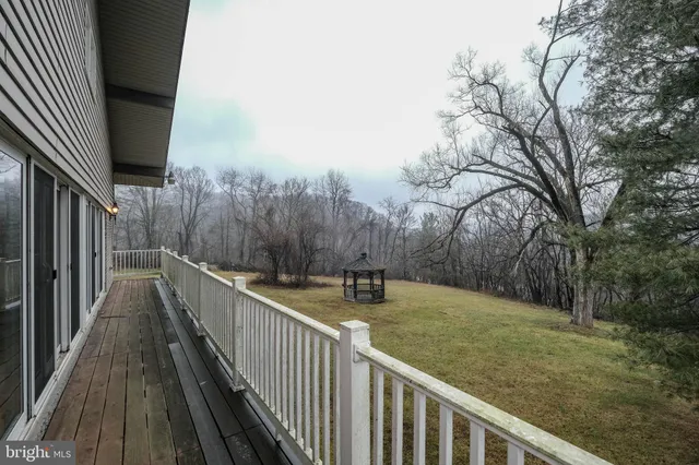 a view of a hallway with wooden floor and closet