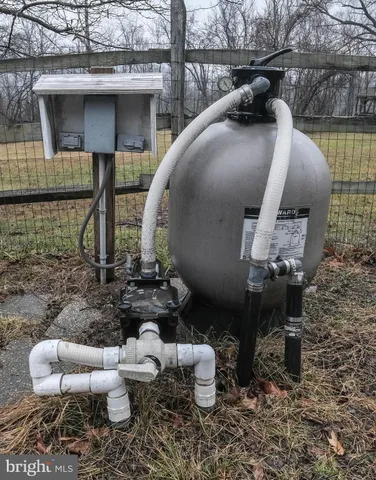 a kitchen with granite countertop a refrigerator and stainless steel appliances