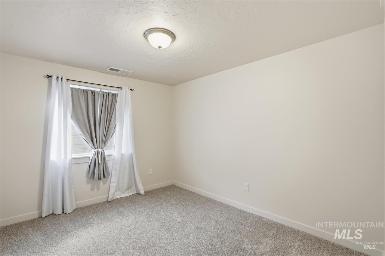 449 West Winnipeg Street Meridian, ID 83642 - Photo 29 of 49 Spare room featuring light carpet and a textured ceiling