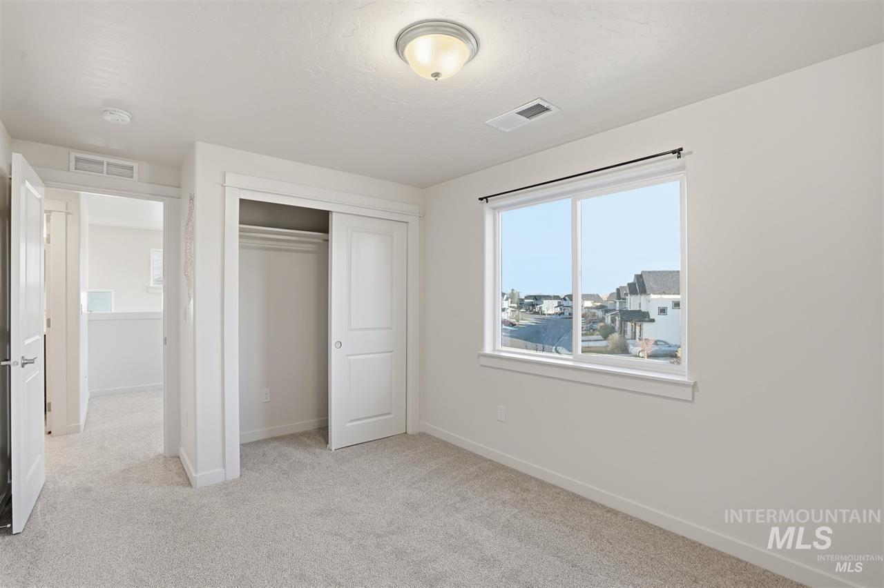 449 West Winnipeg Street Meridian, ID 83642 - Photo 32 of 49 Unfurnished bedroom featuring light carpet and a closet