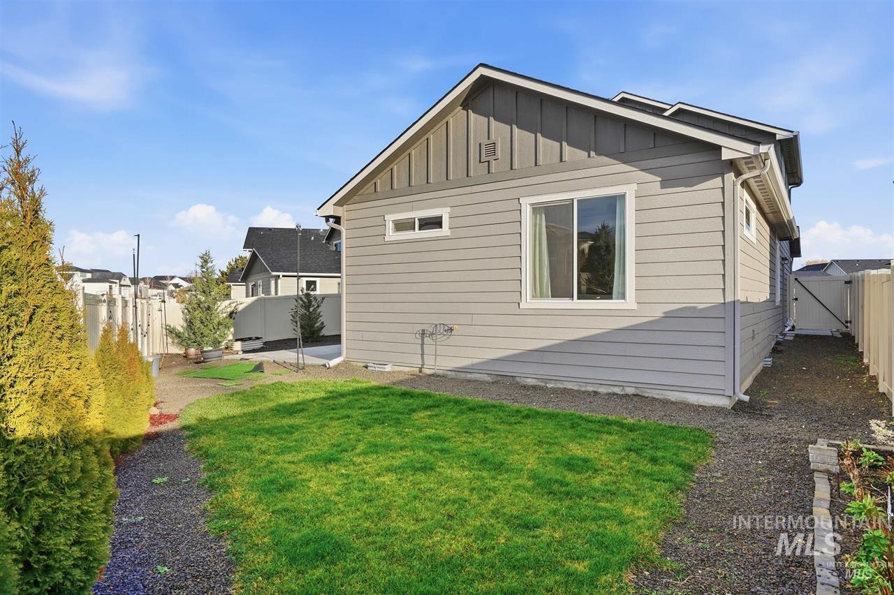 449 West Winnipeg Street Meridian, ID 83642 - Photo 36 of 49 View of side of home featuring board and batten siding, a fenced backyard, and a gate