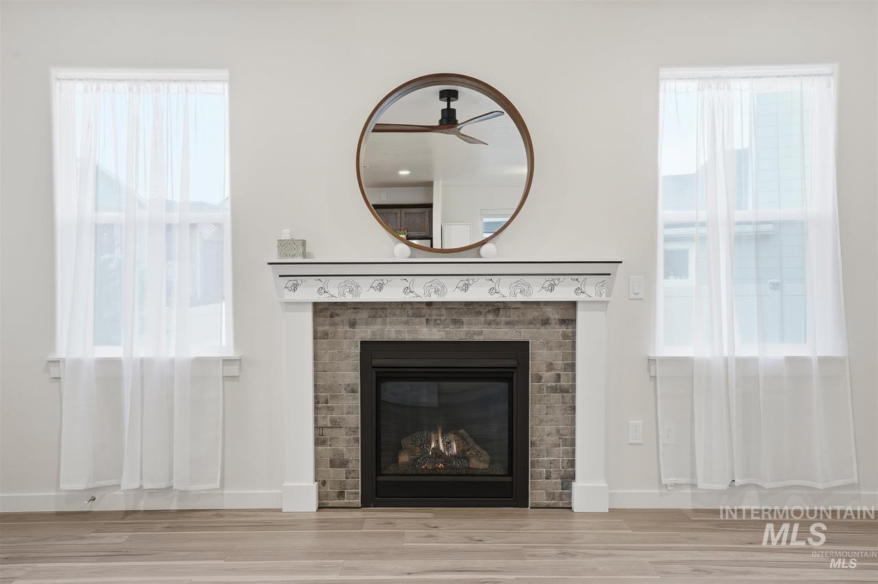 449 West Winnipeg Street Meridian, ID 83642 - Photo 5 of 49 Detailed view of wood finished floors, a fireplace, and a ceiling fan