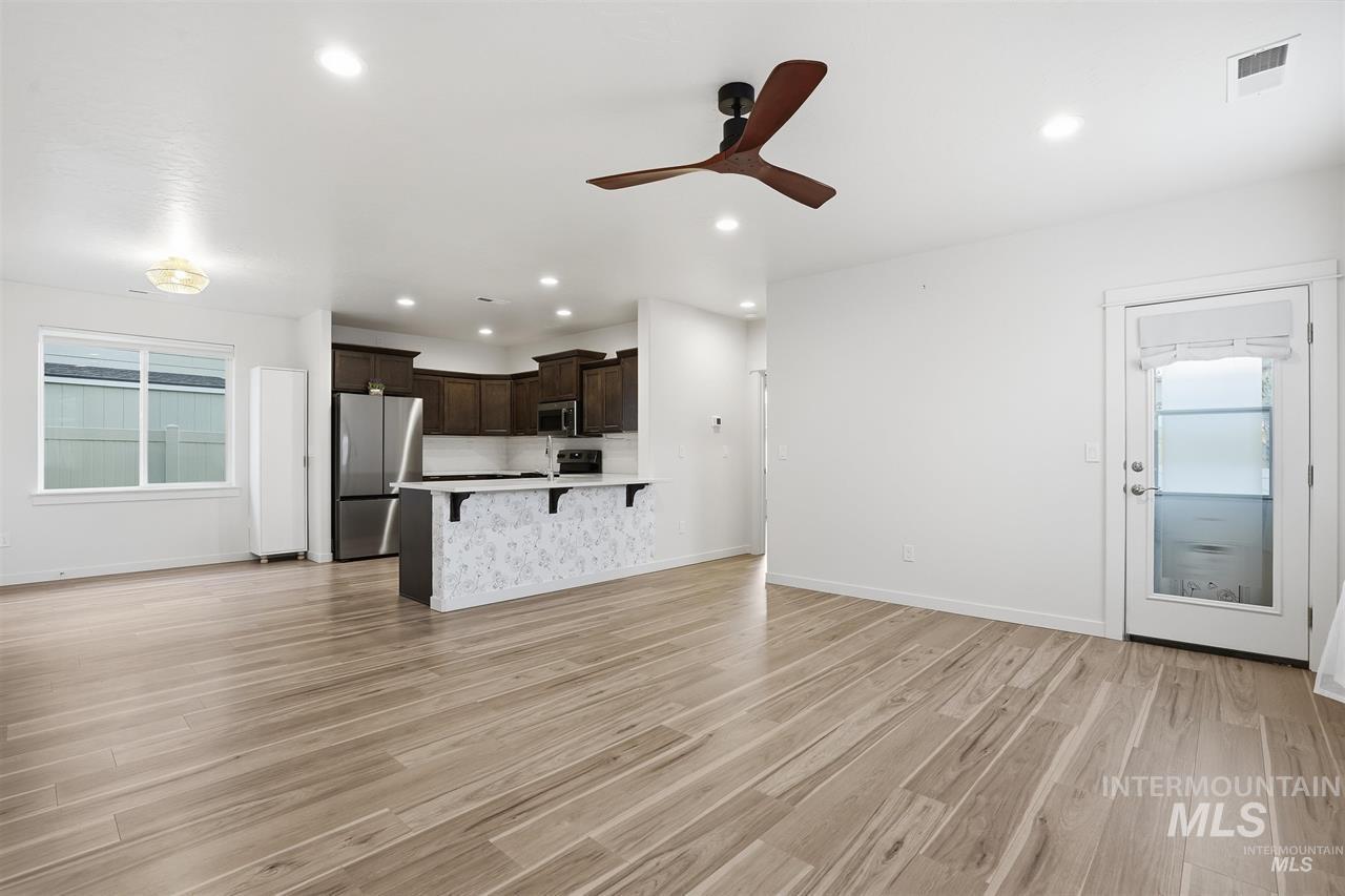 449 West Winnipeg Street Meridian, ID 83642 - Photo 8 of 49 Unfurnished living room with healthy amount of natural light, light wood-type flooring, a ceiling fan, and recessed lighting