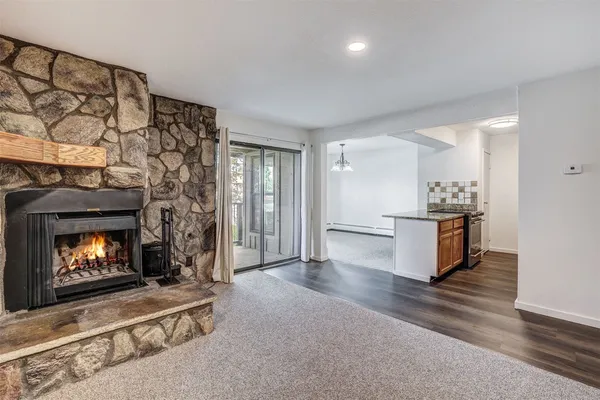 a view of kitchen with refrigerator and fireplace