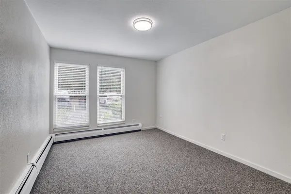 an empty room with a empty space and a large window