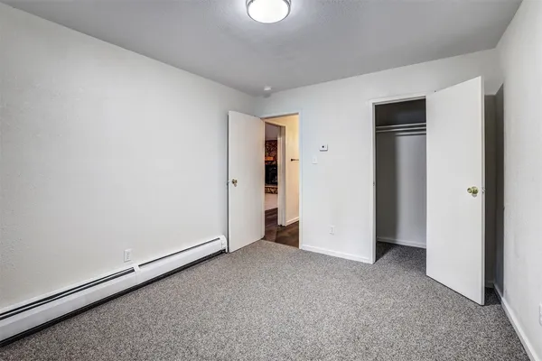 an empty room with closet area