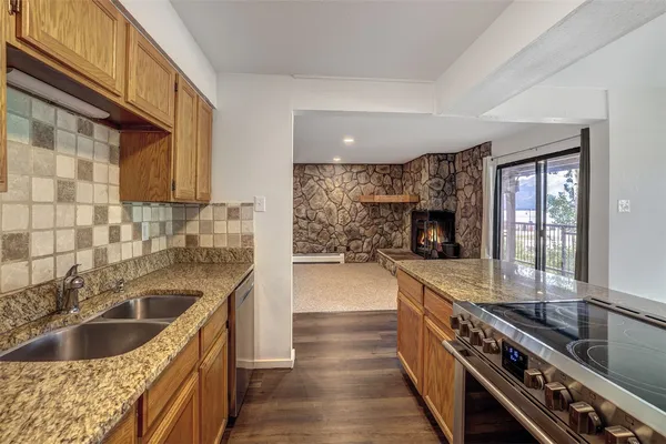 a kitchen with a sink and a stove top oven