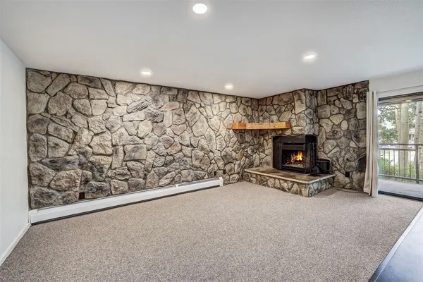 a living room with a fireplace and a flat screen tv