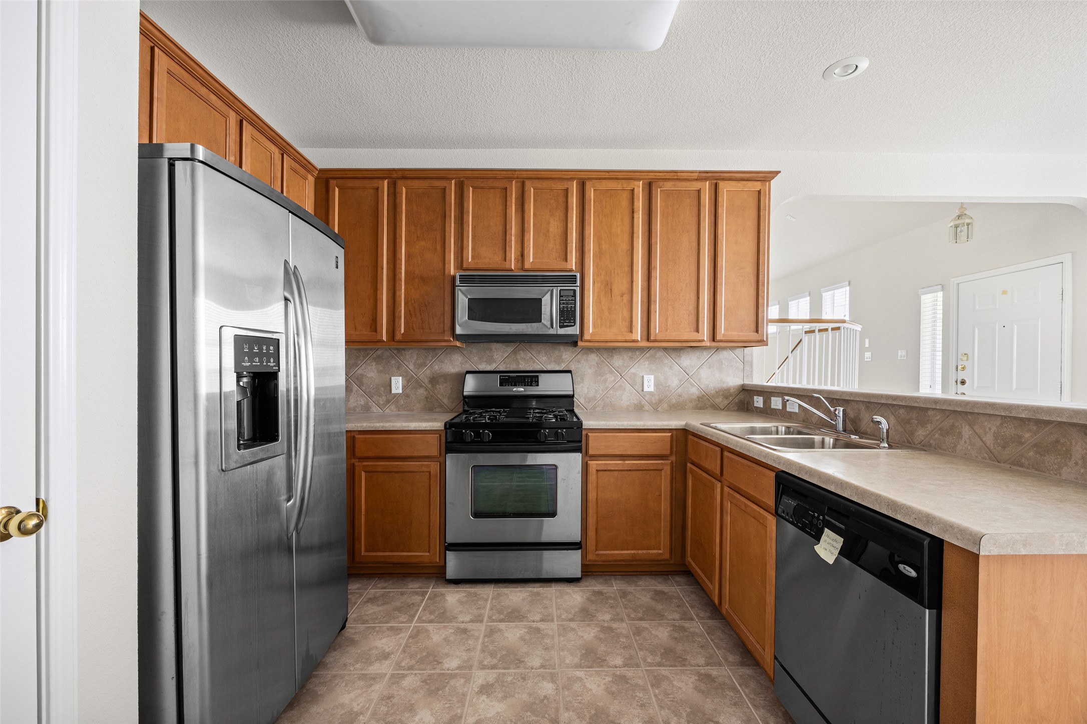 1900 Scofield Ridge Parkway, Unit 503 Austin, TX 78727 - Photo 8 of 26 a kitchen with stainless steel appliances granite countertop a stove a sink dishwasher a refrigerator and a microwave oven