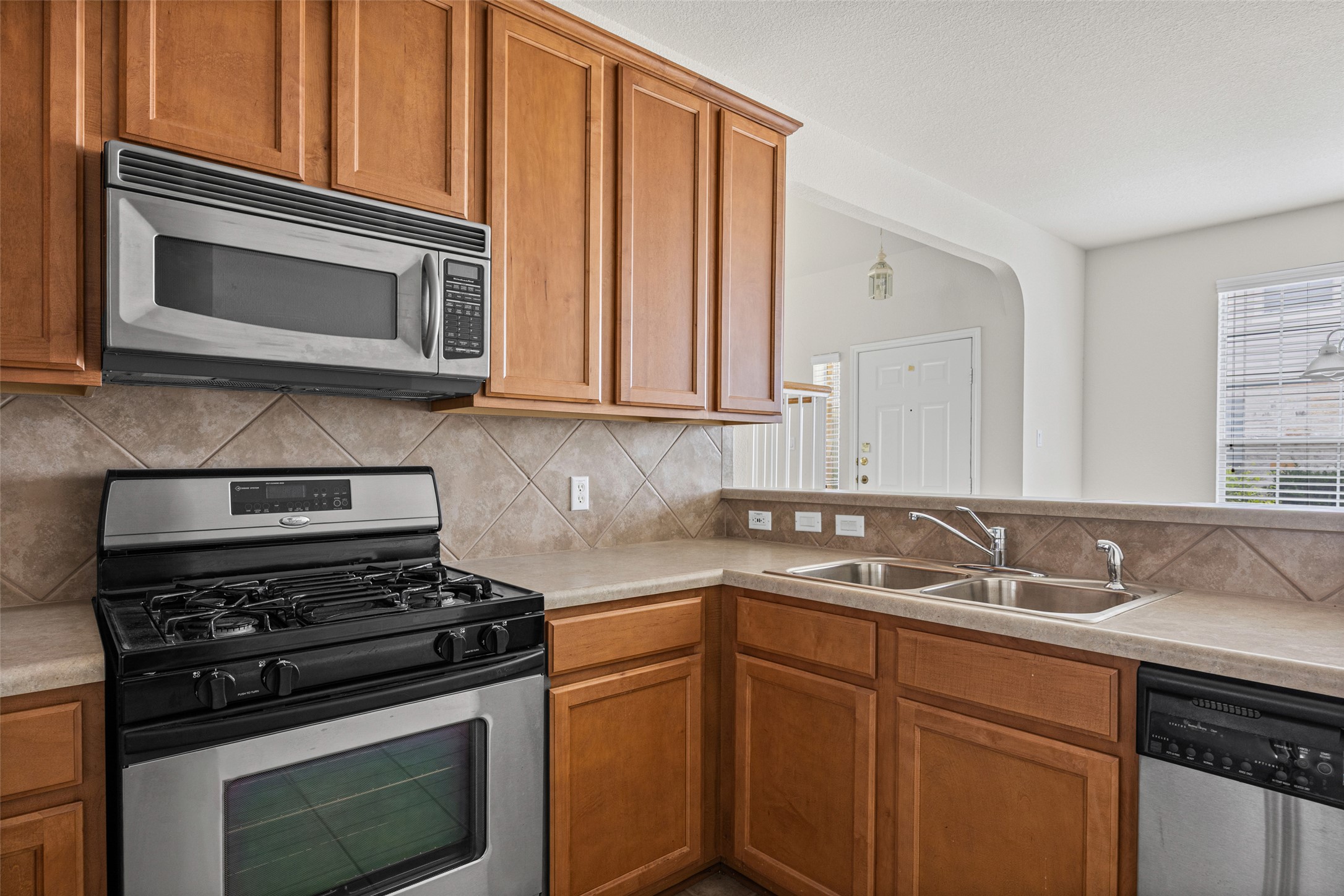 1900 Scofield Ridge Parkway, Unit 503 Austin, TX 78727 - Photo 9 of 26 a kitchen with granite countertop cabinets stainless steel appliances and wooden cabinets