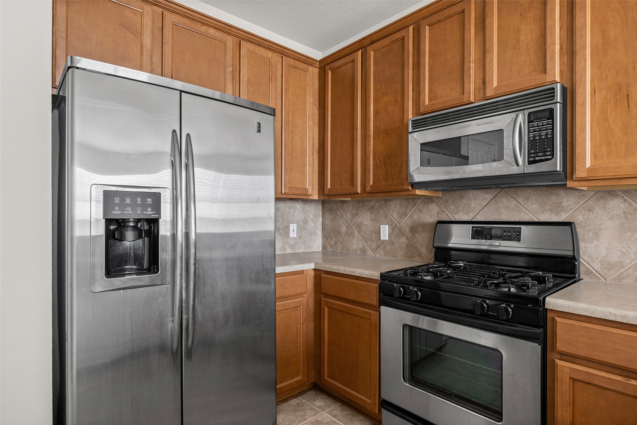 1900 Scofield Ridge Parkway, Unit 503 Austin, TX 78727 - Photo 10 of 26 a kitchen with stainless steel appliances granite countertop a refrigerator stove and microwave