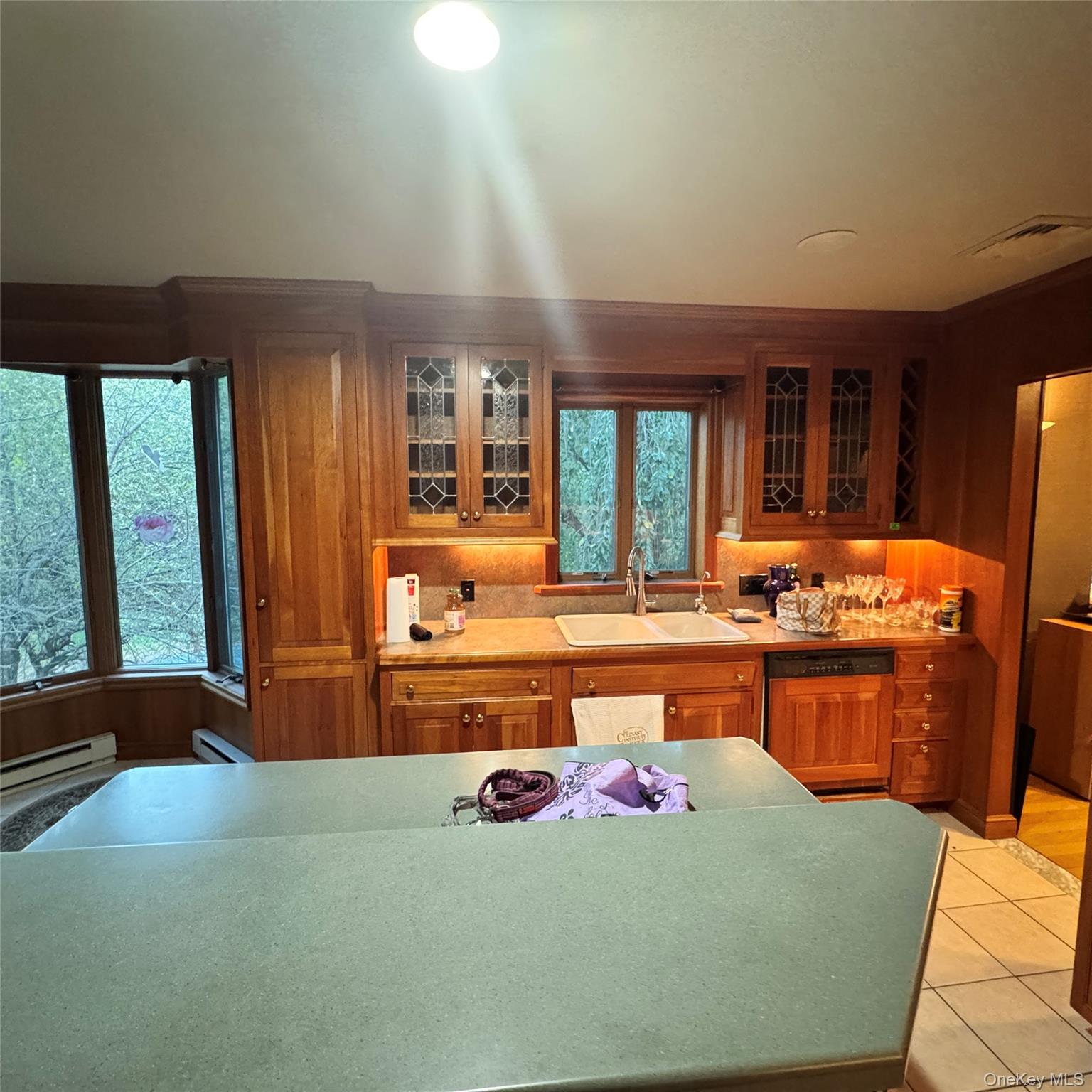 67 Steele Road New Windsor, NY 12553 - Photo 2 of 34 Wood-finish cabinetry with leaded glass inserts, double basin sink, and ample countertop space
