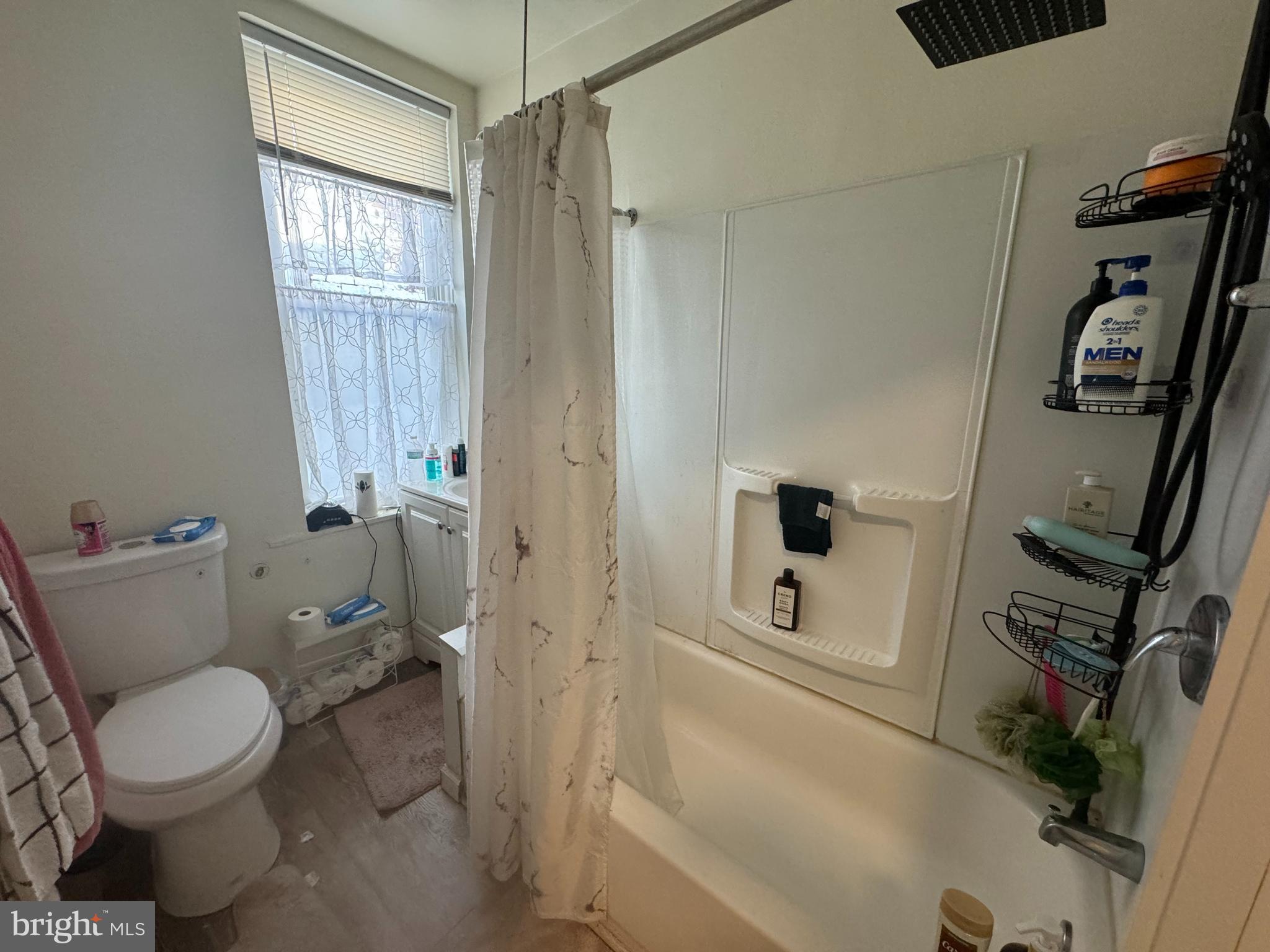 3835 North Percy Street Philadelphia, PA 19140 - Photo 5 of 7 a bathroom with a toilet a sink and a shower