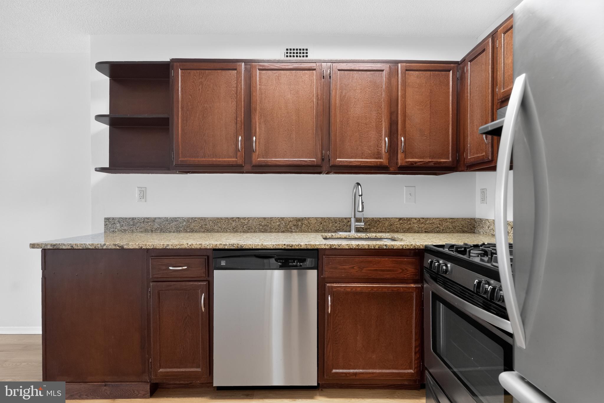 5225 Pooks Hill Road, Unit 1302N Bethesda, MD 20814 - Photo 14 of 19 a kitchen with a stove and a microwave