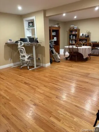 a view of a room with furniture and wooden floor