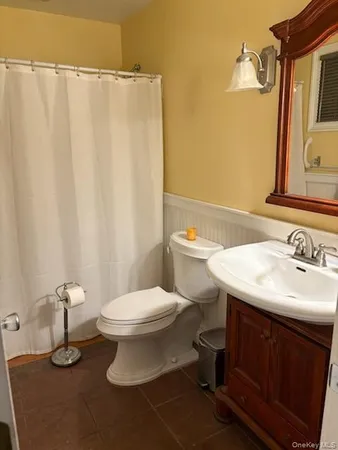 a bathroom with a sink a toilet and mirror