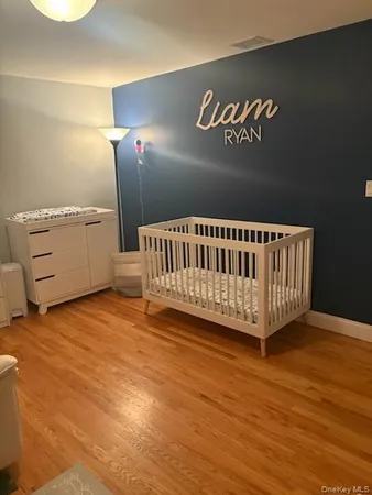 a view of a room with furniture and wooden floor