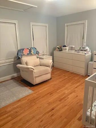 a living room with furniture and a mirror