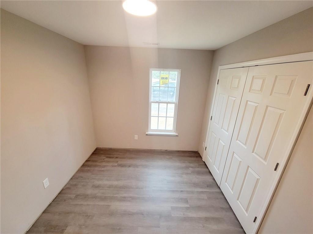 1049 East Hanover Road Graham, NC 27253 - Photo 11 of 14 an empty room with wooden floor and windows